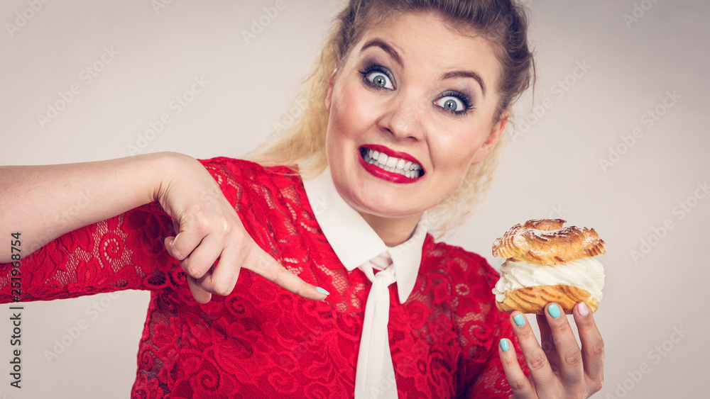 Happy woman holding choux puff cake