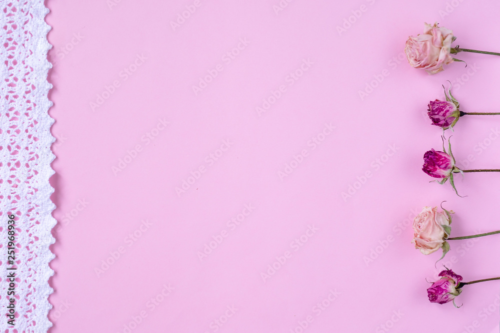 Small dry roses on pastel pink background. Happy Women's Day, Wedding, Mother's Day, Easter, Valentine's Day. Flat lay, top view, copy space Small dry roses on pastel pink background. Happy Women's Day, Wedding, Mother's Day, Easter, Valentine's Day. Flat lay, top view, copy space