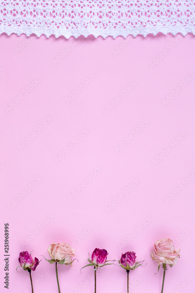 Small dry roses on pastel pink background. Happy Women's Day, Wedding, Mother's Day, Easter, Valentine's Day. Flat lay, top view, copy space Small dry roses on pastel pink background. Happy Women's Day, Wedding, Mother's Day, Easter, Valentine's Day. Flat lay, top view, copy space