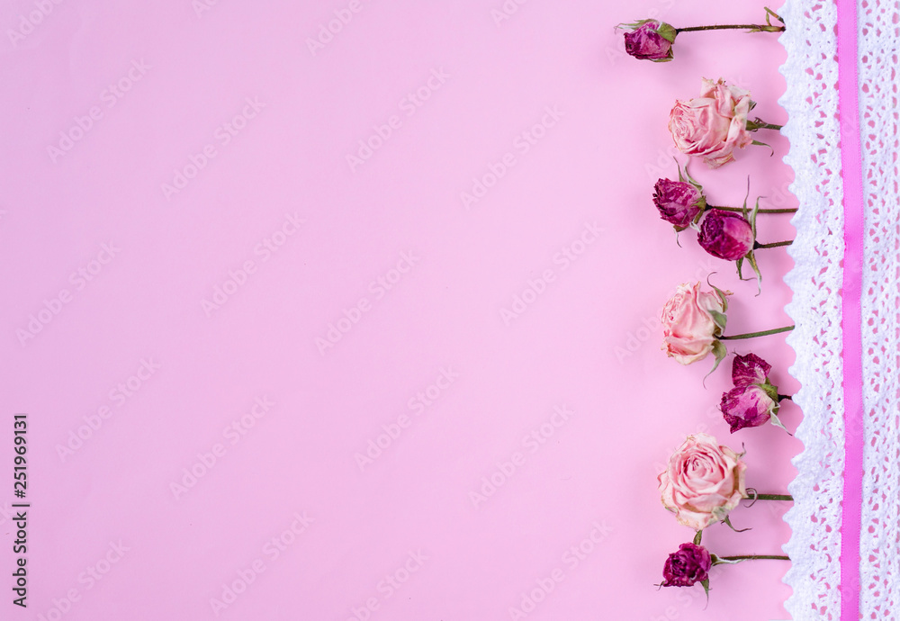 Small dry roses on pastel pink background. Happy Women's Day, Wedding, Mother's Day, Easter, Valentine's Day. Flat lay, top view, copy space Small dry roses on pastel pink background. Happy Women's Day, Wedding, Mother's Day, Easter, Valentine's Day. Flat lay, top view, copy space