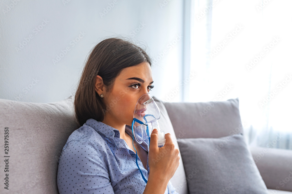 Portrait of a young woman doing inhalation at home Portrait of a young woman doing inhalation at home