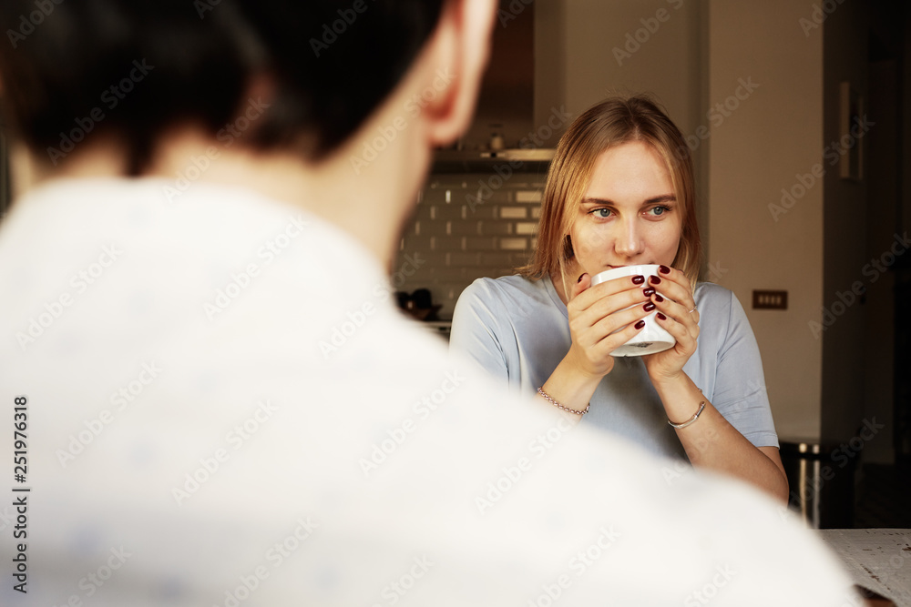 Conversation of confident man and young blond woman at home. Conversation of confident man and young blond woman at home.