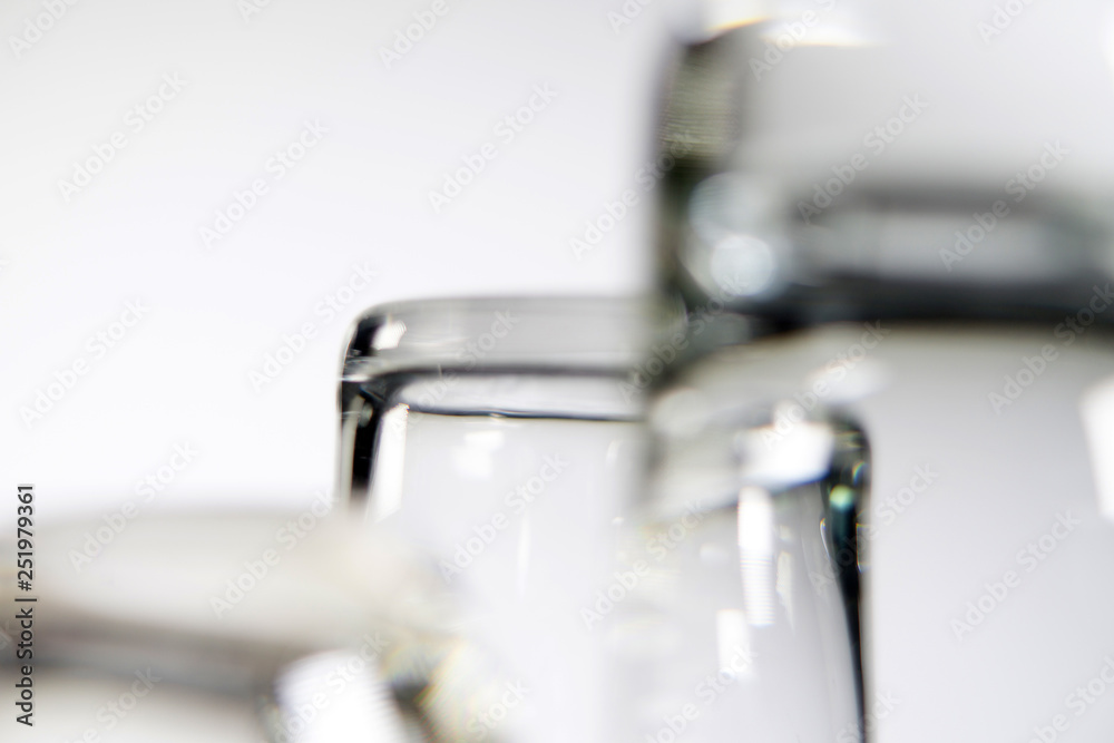 Close up of three different empty shot glasses on white background.