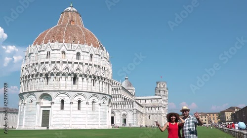 Happy tourists taking souvenir photo in Pisa, Italy, with top rated attraction monument of Italy. Smiling couple travel to Tuscany, cheerful people having holidays picture, tourism destination