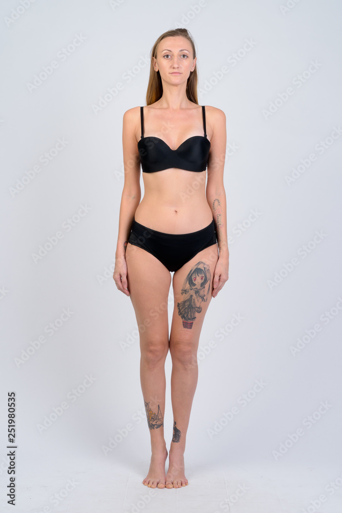 Full body shot of blonde woman wearing bikini