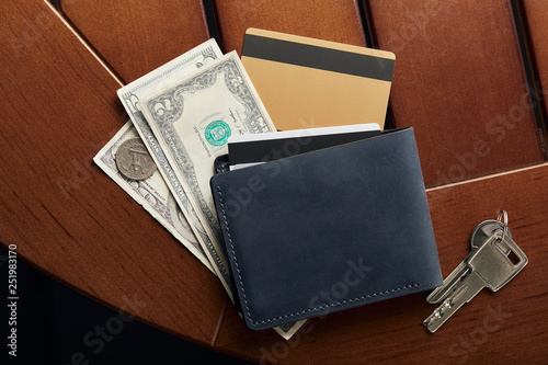 top view of credit cards, cash, wallet and keys on surface