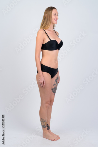 Full body shot of happy blonde woman in bikini thinking © Ranta Images