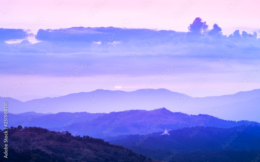 Landscape view of sunrise in early morning on high angle view with misty covered over layers mountain hills at thailand