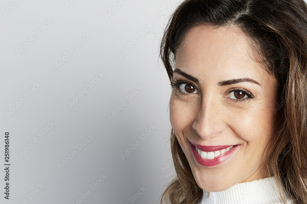 Monochrome shot of happy caucasian businesswoman with positive smile, has crisp dark hair, isolated on white wall background. Monochrome shot of happy caucasian businesswoman with positive smile, has crisp dark hair, isolated on white wall background.