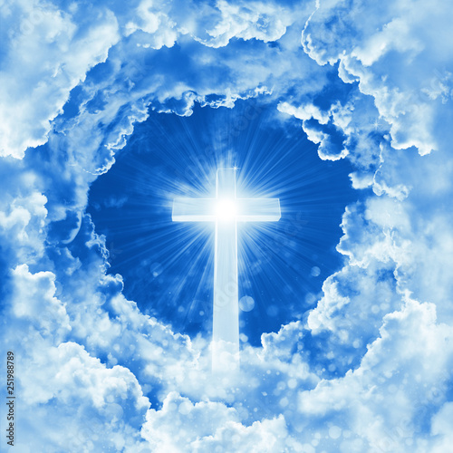 Concept of christian religion shining cross on the background of dramatic cloudy sky. Sky with cross and beautiful cloud. Peaceful religious background. Divine shining heaven, light