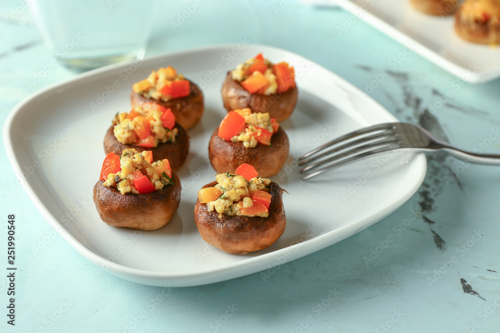 Plate with tasty stuffed mushrooms on table Plate with tasty stuffed mushrooms on table