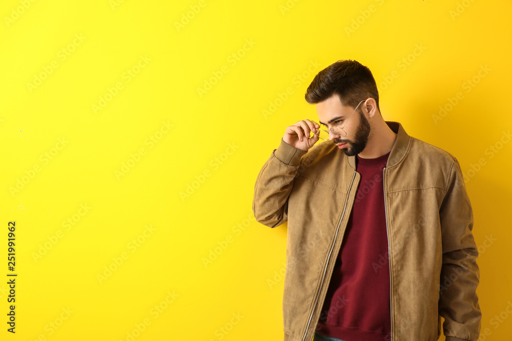 Fashionable young man on color background Fashionable young man on color background