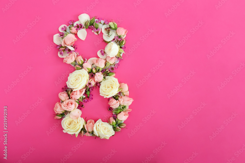 Figure 8 made of fresh flowers on color background