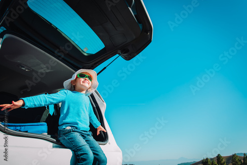 happy little girl enjoy travel by car in nature