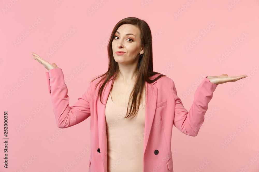 Portrait of perplexed puzzled young woman wearing jacket looking camera, spreading hands isolated on pastel pink background in studio. People sincere emotions, lifestyle concept. Mock up copy space. Portrait of perplexed puzzled young woman wearing jacket looking camera, spreading hands isolated on pastel pink background in studio. People sincere emotions, lifestyle concept. Mock up copy space.