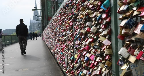 people walking on the Cologne Bridge in Germany, bridge with colorful locks