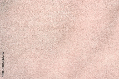 Suede is artificial. Light pink suede fabric close-up. Velvet texture background
