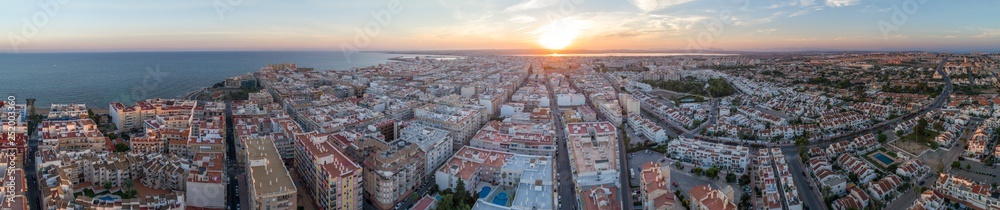 Aerial panoramic view of Torrevieja. Living districts and colorful summer sunset