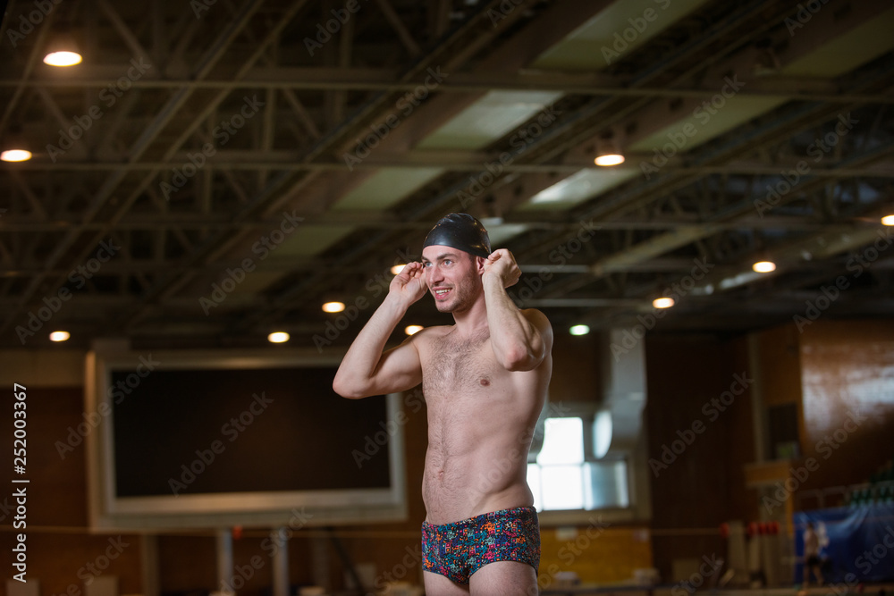 Swimmer with a cap on getting ready to swim.