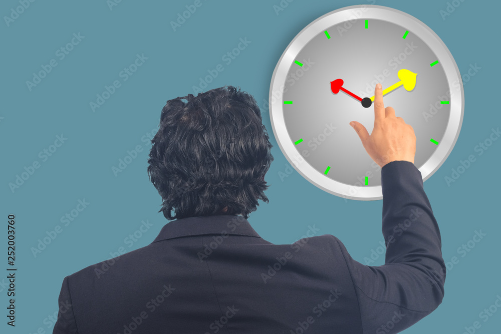 Business man point to clock on background. Business man point to clock on background.