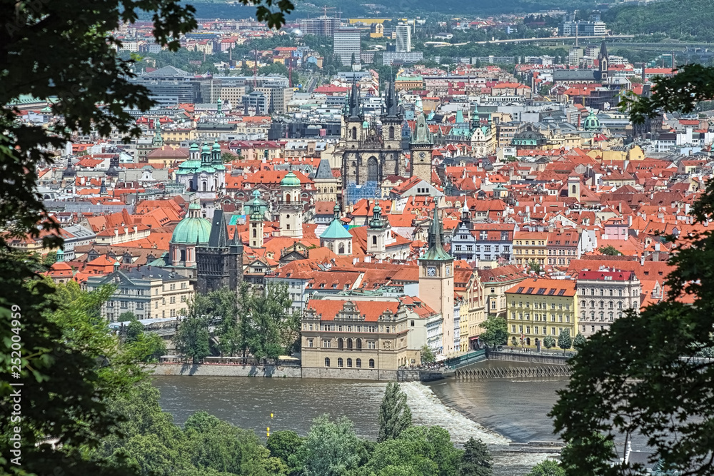 View of the Old Town of Prague from Petrin Hill, Czech Republic. Photo taken by telephoto lens through the gap between trees.