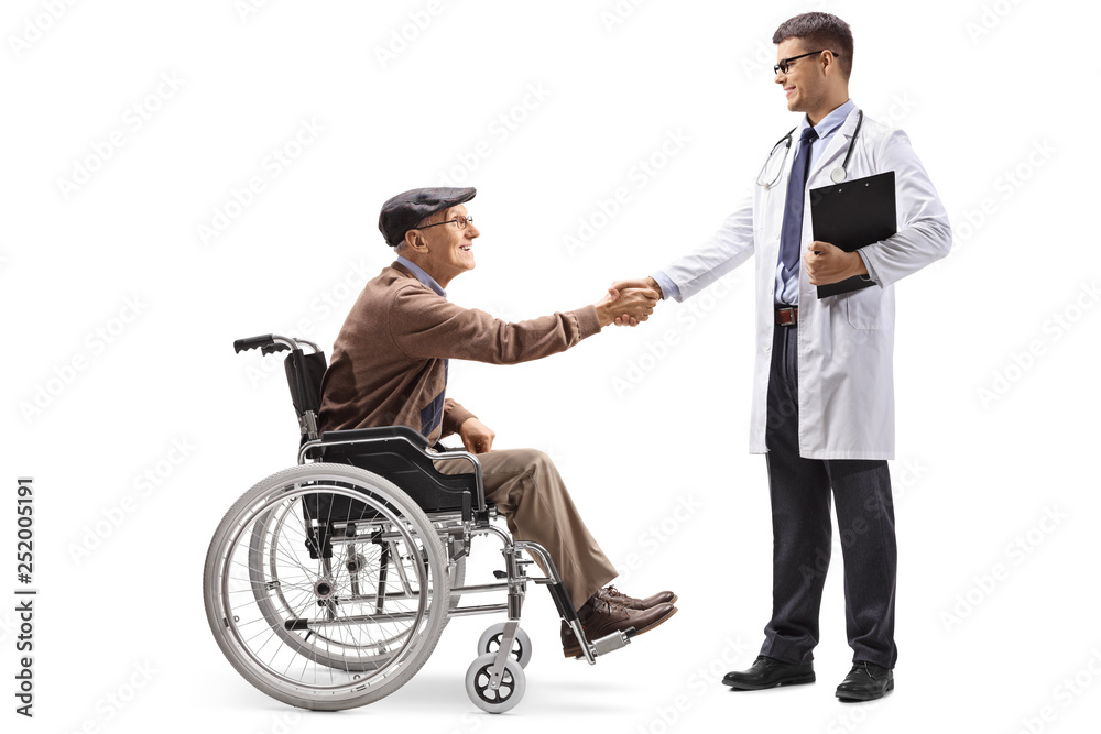 Senior man in a wheelchair shaking hands with a young male doctor Senior man in a wheelchair shaking hands with a young male doctor