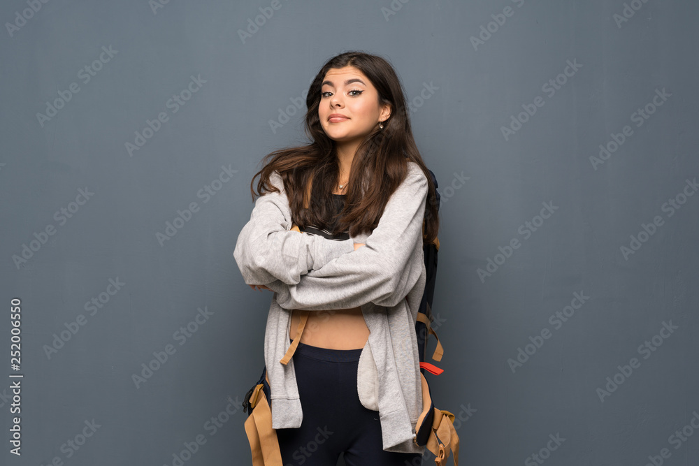 Teenager traveler girl over wall making doubts gesture while lifting the shoulders Teenager traveler girl over wall making doubts gesture while lifting the shoulders