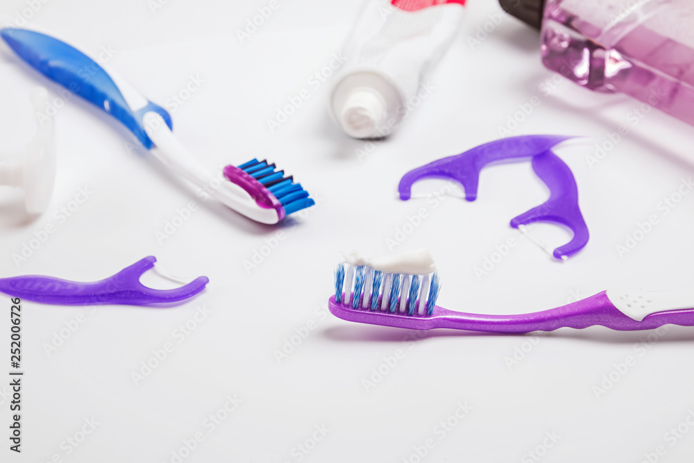 Tooth brush, floss and other dental care products on the white background Tooth brush, floss and other dental care products on the white background