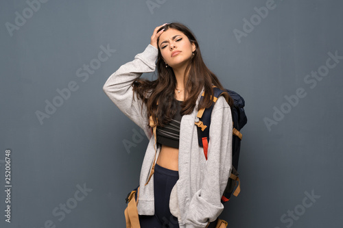 Teenager traveler girl over wall with an expression of frustration and not understanding
