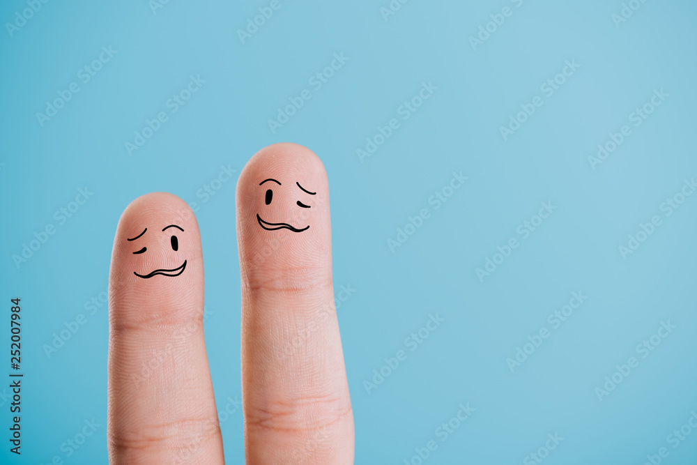 cropped view of confused human fingers isolated on blue cropped view of confused human fingers isolated on blue