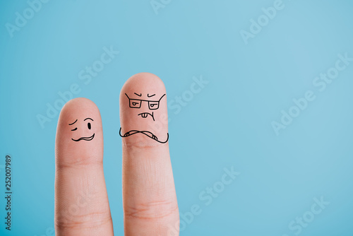 cropped view of confused fingers isolated on blue