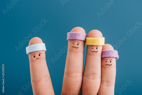 cropped view of confused sporty fingers in headbands isolated on blue