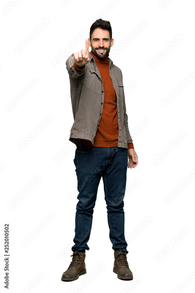 Full-length shot of Handsome man with beard showing and lifting a finger on isolated white background Full-length shot of Handsome man with beard showing and lifting a finger on isolated white background