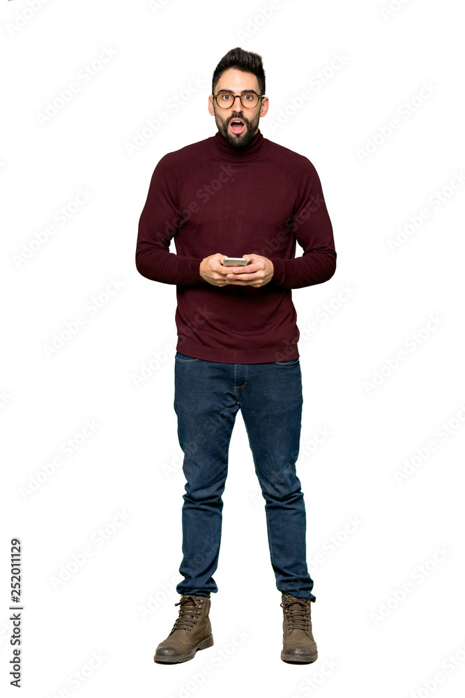 Full-length shot of Handsome man with glasses surprised and sending a message on isolated white background Full-length shot of Handsome man with glasses surprised and sending a message on isolated white background