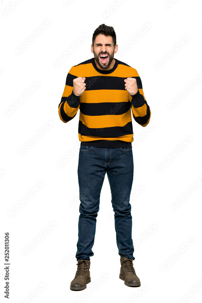 Full-length shot of Handsome man with striped sweater frustrated by a bad situation on isolated white background Full-length shot of Handsome man with striped sweater frustrated by a bad situation on isolated white background