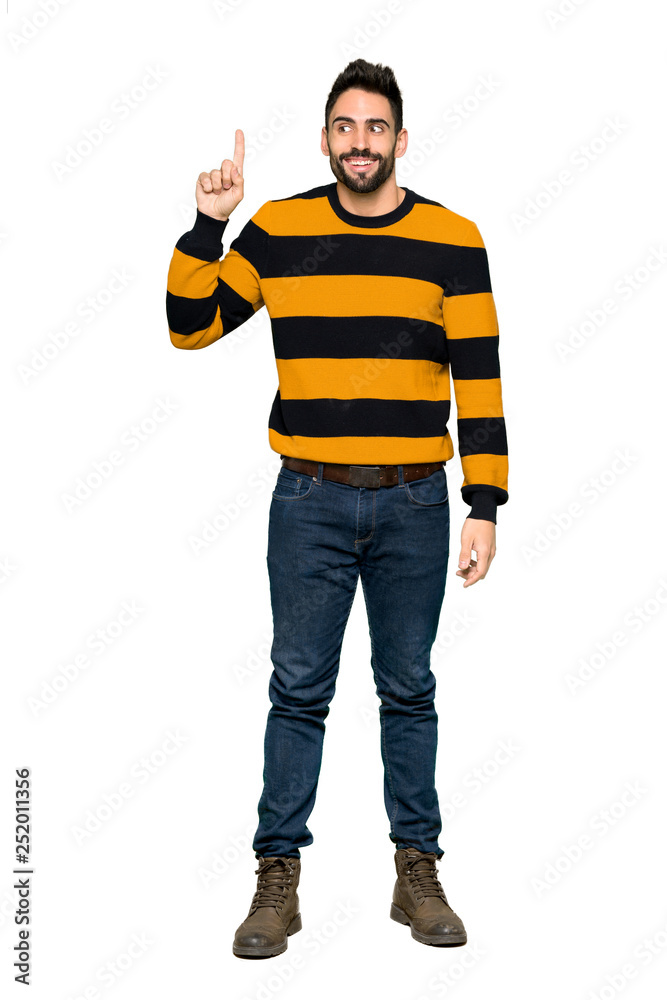 Full-length shot of Handsome man with striped sweater intending to realizes the solution while lifting a finger up on isolated white background Full-length shot of Handsome man with striped sweater intending to realizes the solution while lifting a finger up on isolated white background