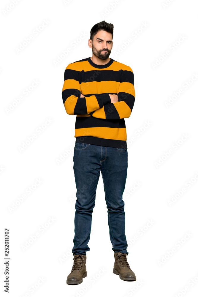 Full-length shot of Handsome man with striped sweater feeling upset on isolated white background Full-length shot of Handsome man with striped sweater feeling upset on isolated white background