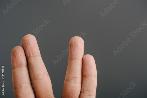 cropped view of human fingers isolated on grey
