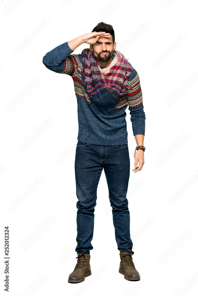 Fototapeta premium Full-length shot of Hippie man looking far away with hand to look something on isolated white background
