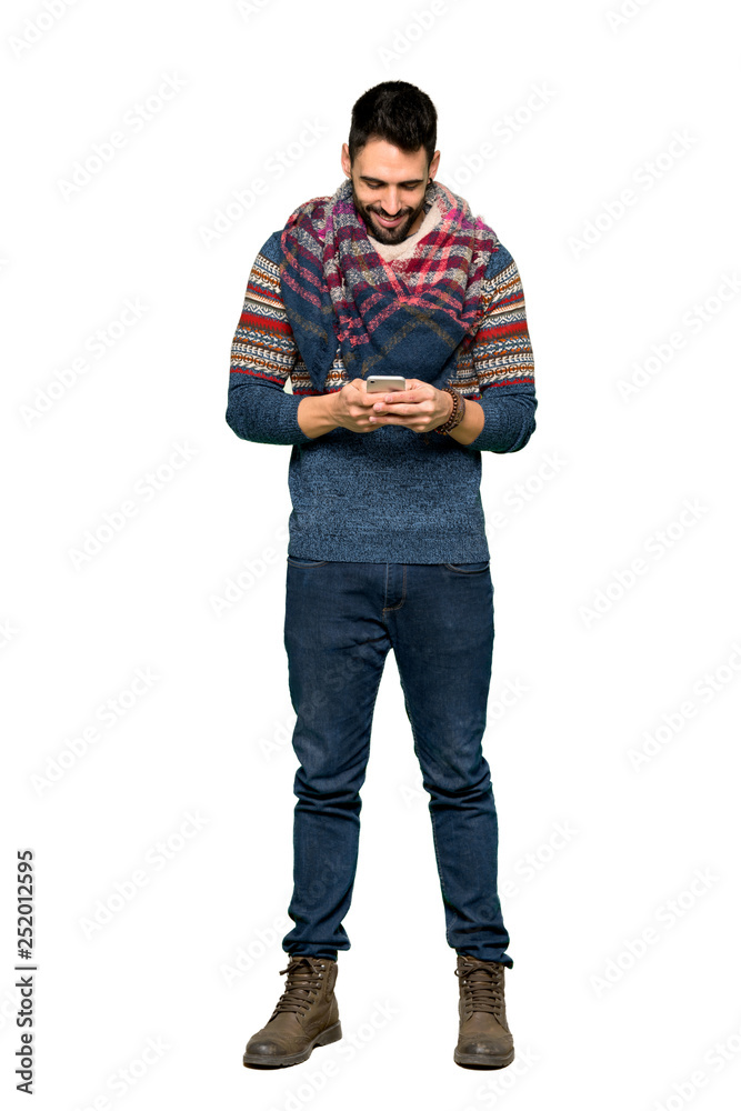 Full-length shot of Hippie man sending a message with the mobile on isolated white background Full-length shot of Hippie man sending a message with the mobile on isolated white background