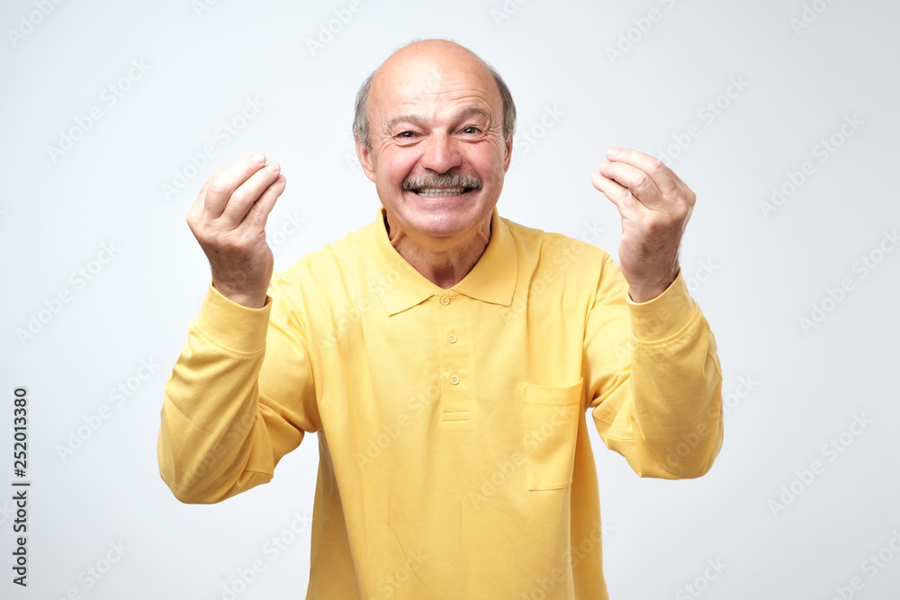 Attractive guy laughing, showing italian gesture, proving his point of view Attractive guy laughing, showing italian gesture, proving his point of view