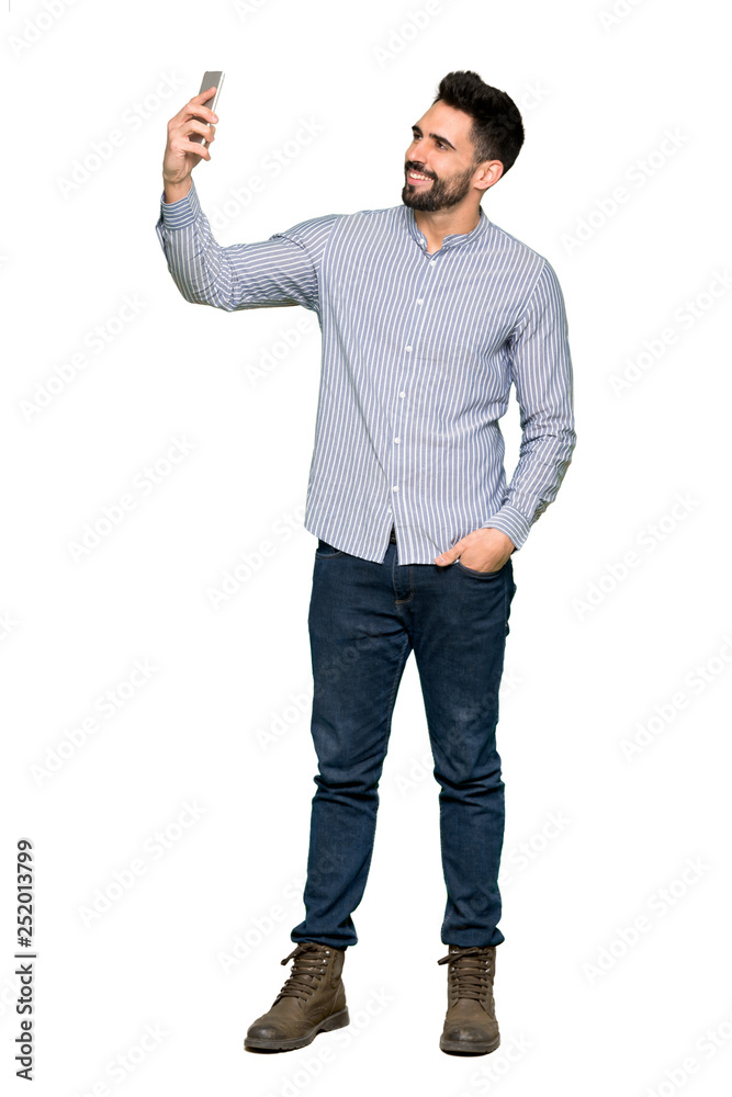Full-length shot of Elegant man with shirt making a selfie on isolated white background Full-length shot of Elegant man with shirt making a selfie on isolated white background