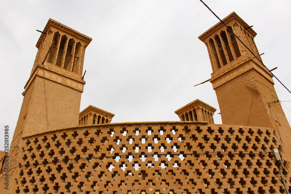 Wind towers in Yazd, Iran. A windtower (wind catcher) is a traditional  Iranian architectural element to create natural ventilation in buildings  Stock Photo | Adobe Stock