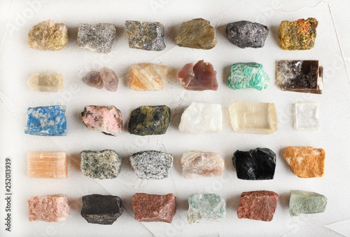 Set of minerals, a collection of rocks, minerals in the box on white cement background. photo