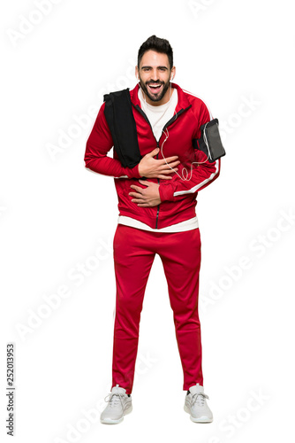 Full-length shot of Handsome sportman smiling a lot while putting hands on chest on isolated white background