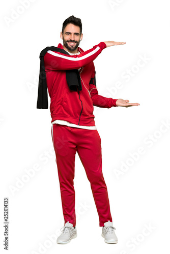 Full-length shot of Handsome sportman holding copyspace to insert an ad on isolated white background