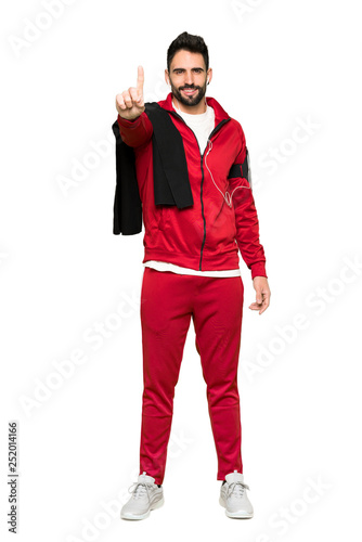Full-length shot of Handsome sportman showing and lifting a finger on isolated white background