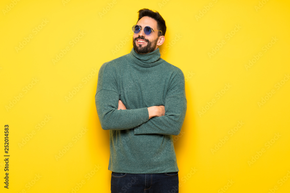 Handsome man with sunglasses looking up while smiling Handsome man with sunglasses looking up while smiling