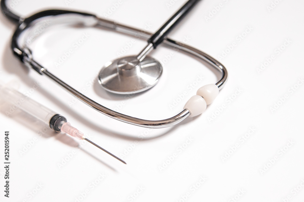 Closeup of medicines, syringes and stethoscope. Clean and bright health care image. Closeup of medicines, syringes and stethoscope. Clean and bright health care image.