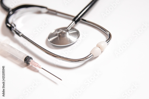 Closeup of medicines  syringes and stethoscope. Clean and bright health care image.